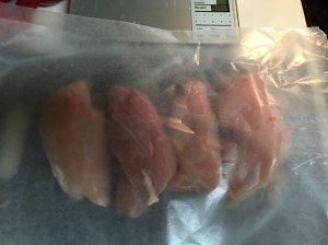 The chicken breasts nestling in between sheets of wax paper, totally unprepared for what's coming next.